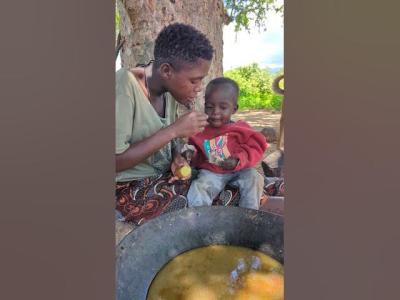 Mother and Son enjoying traditional meal food diningplace africa colonelkkjϟ